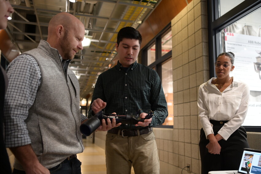Student and faculty at engineering symposium